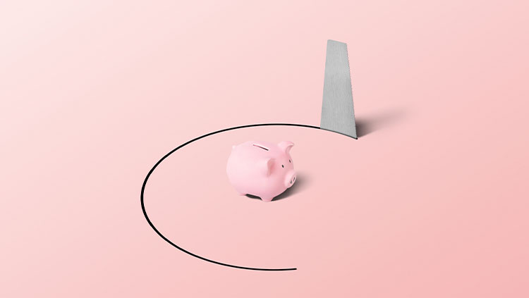 Saw cutting around pink piggy bank